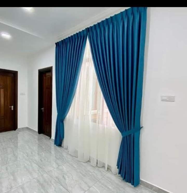 Blue satin curtains with tiebacks installed by Guru's Decor
